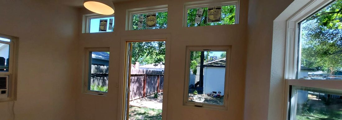 Modern studio with three transom windows above the entry door