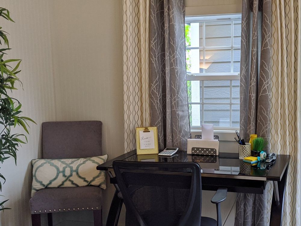 Finished studio set up as a home office with desk and window
